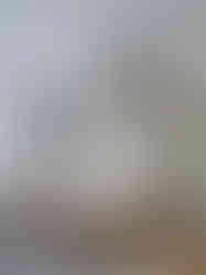 Intentional coffee table styling featuring design books, artisan decor objects, and textured textiles