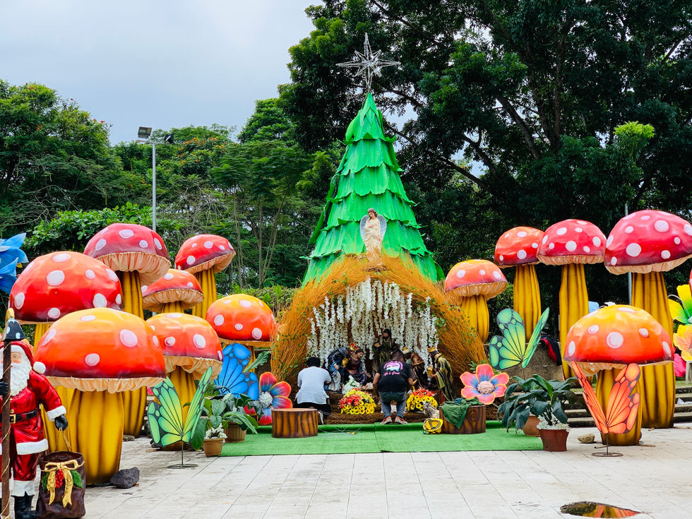 Colorful outdoor display with mushrooms and a tree.