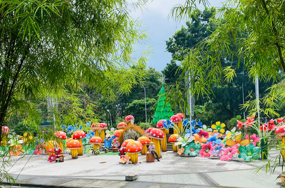 Colorful mushroom and flower sculptures in a park setting.