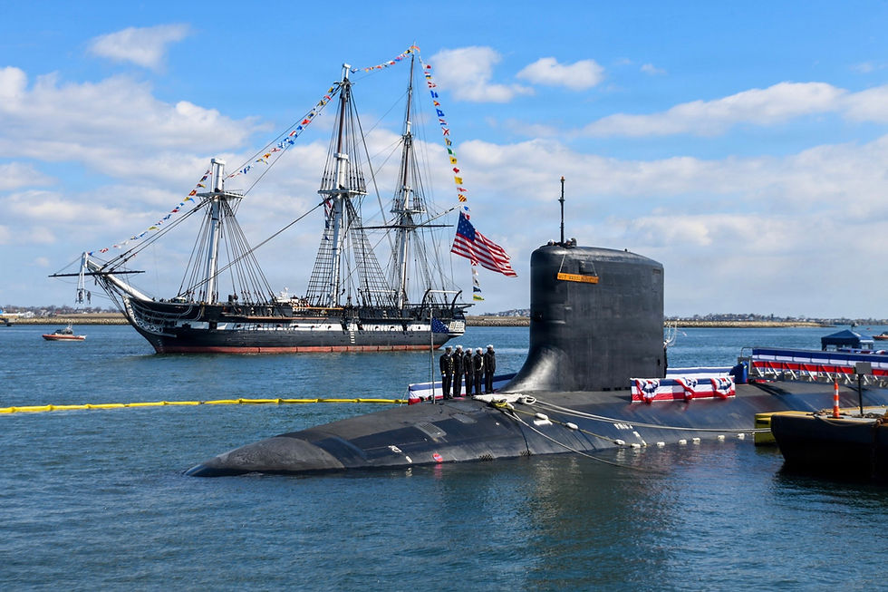 Eye-level view of a Virginia-class submarine docked at a shipyard