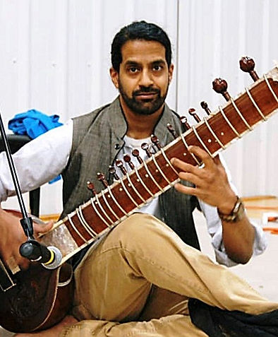 Kevin playing his sitar at a concert in Long Island, NY