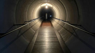 A long dark tunnel with a light at the end representing the journey through the AI pilot trap toward a successful ai adoption strategy.