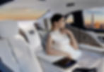 A woman dressed elegantly sits in the luxurious backseat of a chauffeur car, with the London skyline visible through the window.
