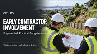 wo civil construction professionals reviewing plans beside a retaining wall on an Auckland hillside.