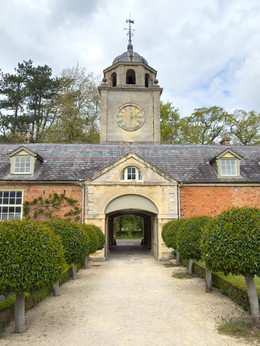 entrance into a walled garden with a clock tower