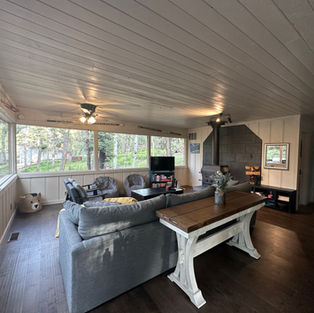 Living room showing table, couch in foreground