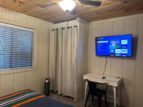 Bedroom 2 Downstairs showing closet, television and white desk