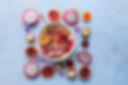 A colorful bowl of food with seeds and fruits