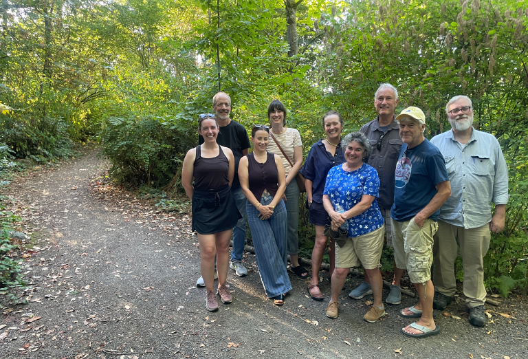 NOW: Katie McClure (front left), director of the Rainier Valley Historical Society, leads a tour through Hitt’s Hill Park on Aug. 22. Others are (from left) Tim Burdick, Renee McCarthy, Aurora Marsalis, Jennie Hubbard, Deb Barker, John Bennett, John Maynard and Scott Hubbard. For more info on Hitt Fireworks Co, visit RainierValleyHistoricalSociety.org. (Clay Eals)