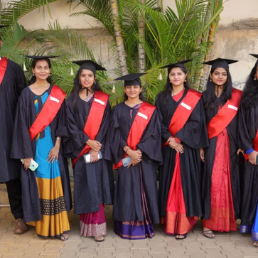 Group of seven graduates in caps and gowns