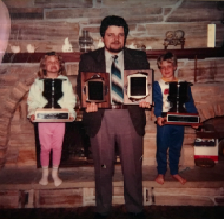 Joe with his kids and his awards