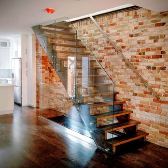Frameless glass stair railing with base shoe system