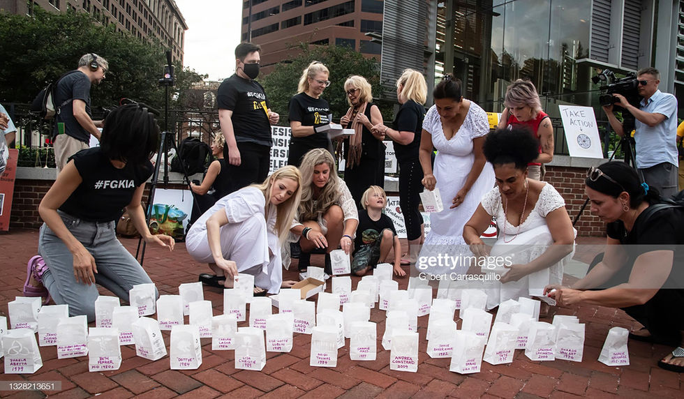 Lili Bernard. Prayers for Andrea Constant Installation, 2021. Ink and stencil on paper bags, electric candels, rubber snake, scales of injustice. Installation and Protest Performance Philadelphia, PA