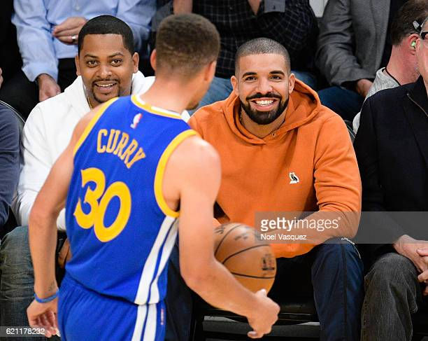 Drake sitting courtside during a Golden states warriors game , Drake and Stephen Curry Photographed