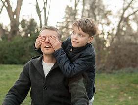 son-covers-his-father-eyes-park.jpg