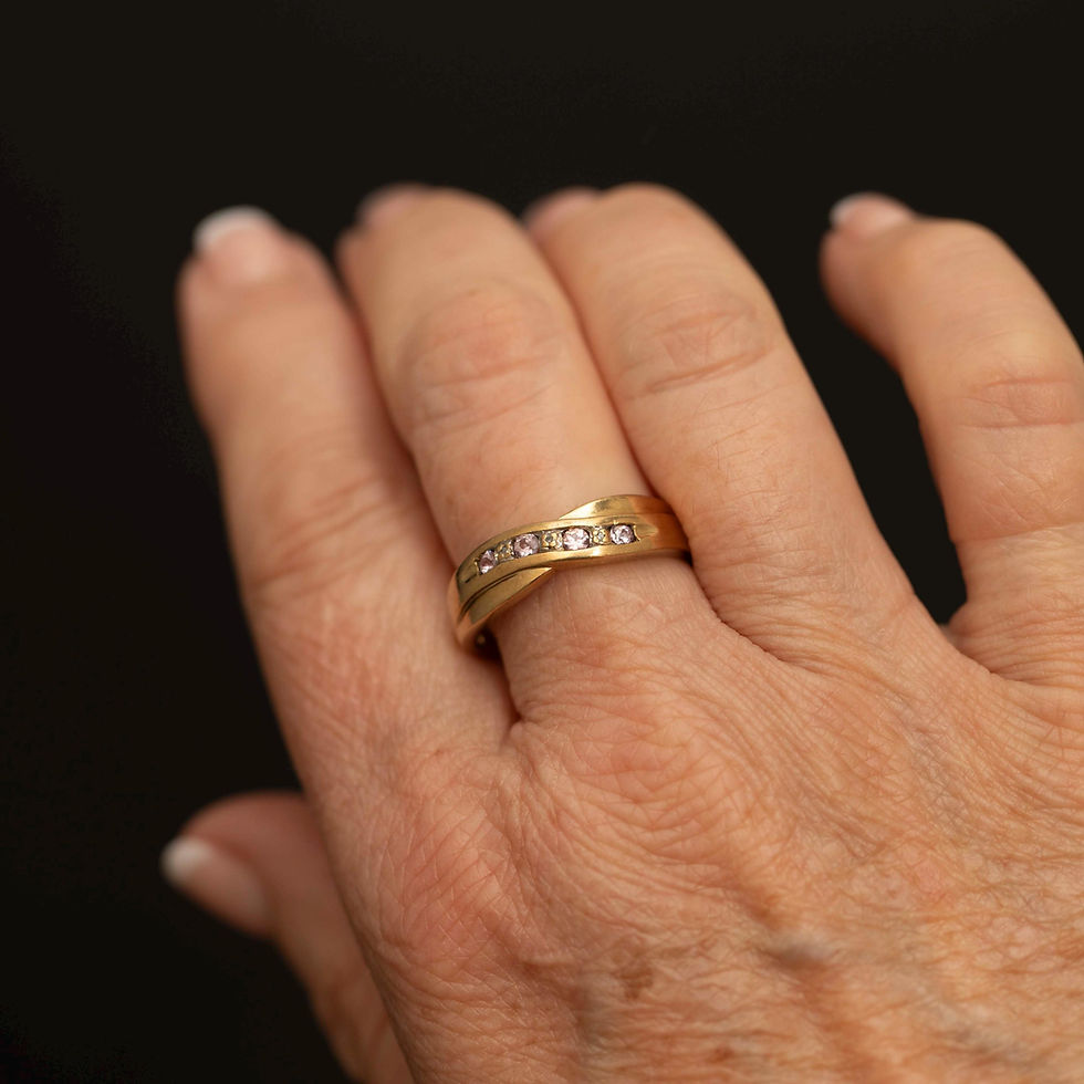 Pink spinel crossover ring worn on hand for scale