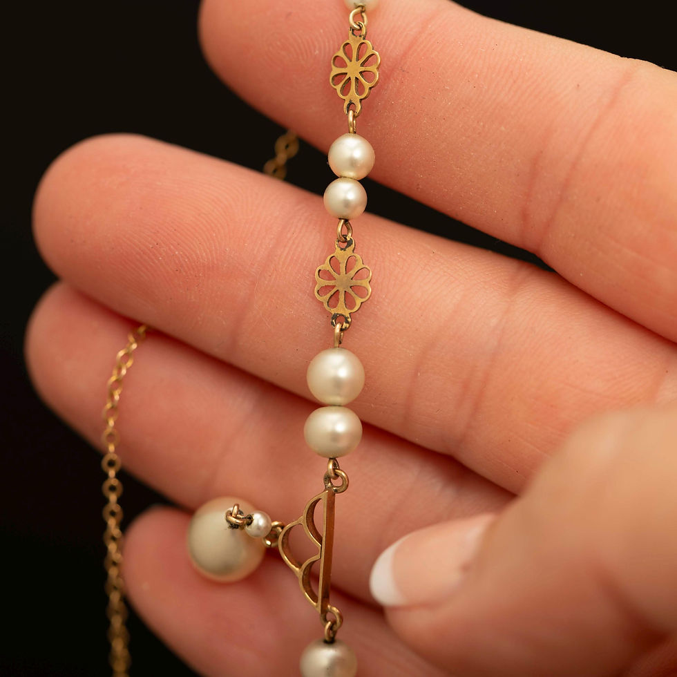 Close up of vintage faux pearl necklace with decorative gold links