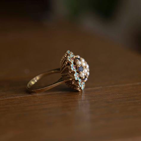 Vintage pearl sapphire cluster ring representing the timeless beauty of vintage jewelry