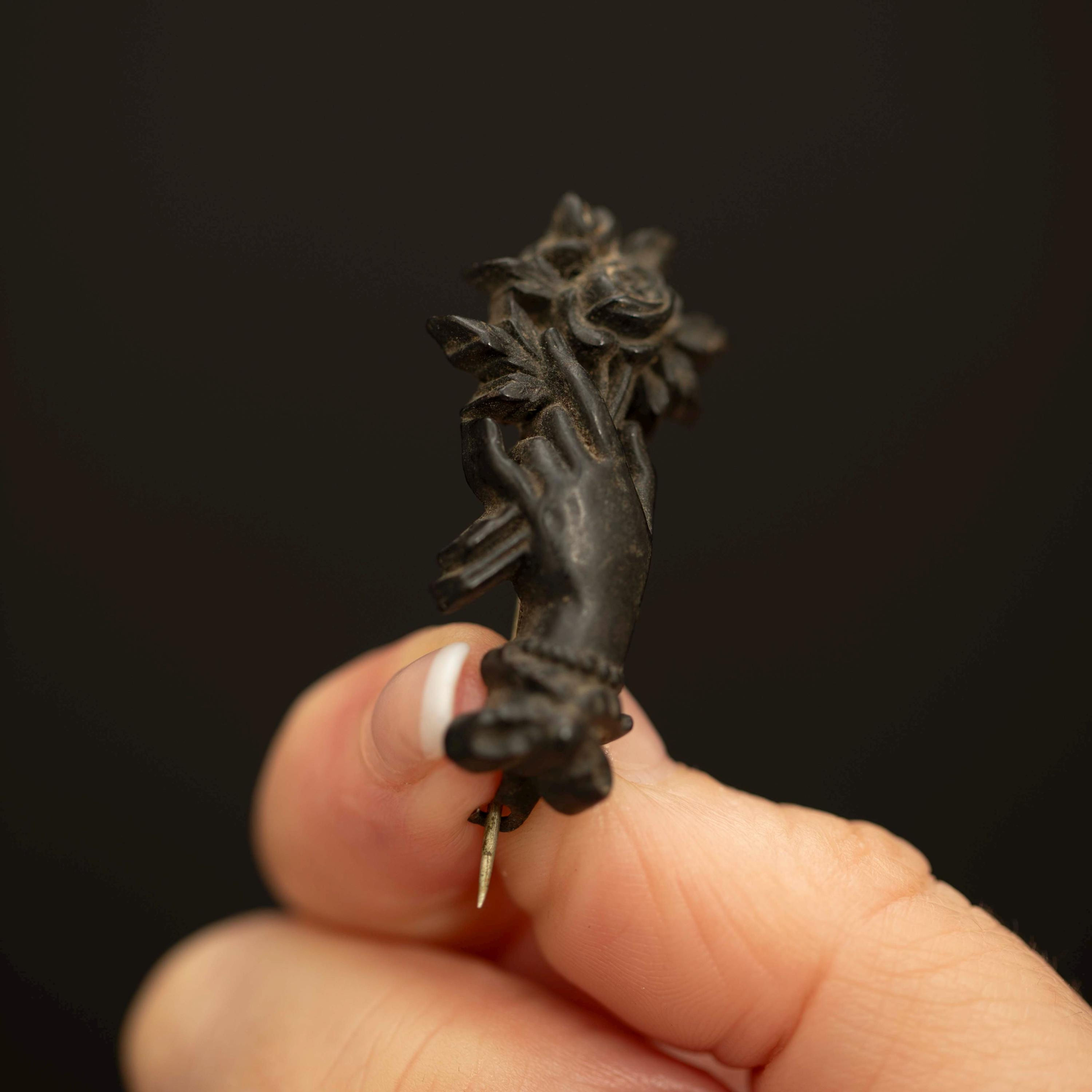 Victorian Gutta Percha Mourning Brooch with Hand Holding Rose