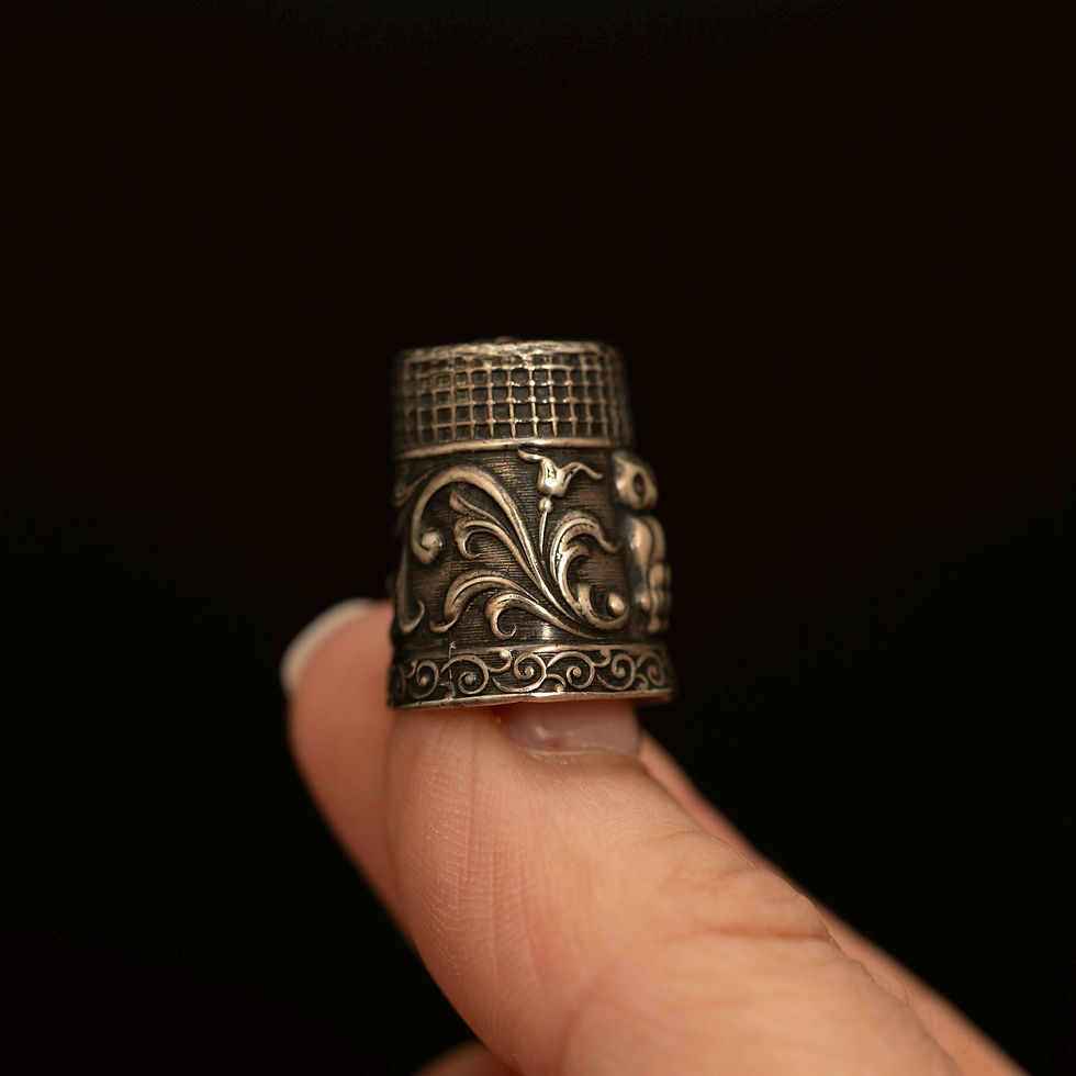 Front view of antique style owl motif sewing thimble