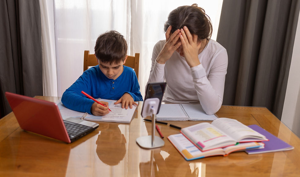 A worried mother and her frustrated son sit at a kitchen table covered in math worksheets and a laptop, illustrating the emotional toll of ineffective or cheap dyscalculia tutoring.