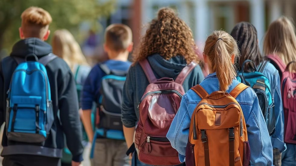 Diverse group of kids with backpacks walking to school on the first day.
