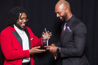 Nolan accepts a Young Journalist of Excellence Award from Washington Association of Black Journalists President Khorri Atkinson at its inaugural Special Honors Gala.
