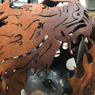 Aged corten steel dragon fire pit