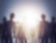 Silhouettes of people standing against a bright light, creating a mysterious mood. Soft gradient background with no visible text.