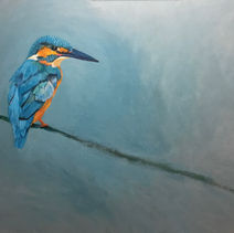 a kingfisher perched on a twig branch with a blue background