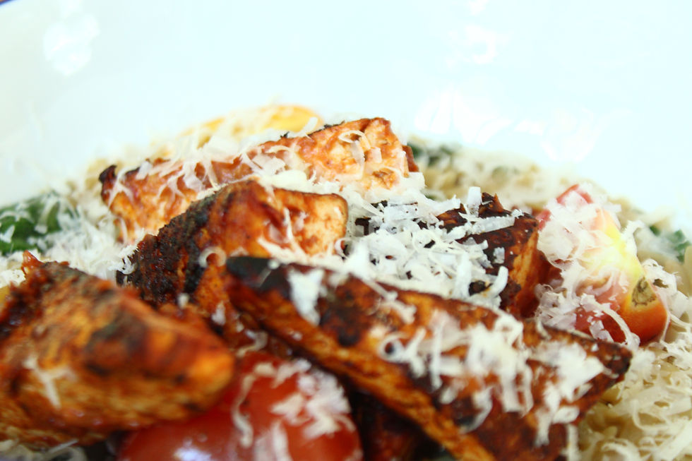 N'duja-spiced tofu served over creamy Tuscan orzo on a workbench