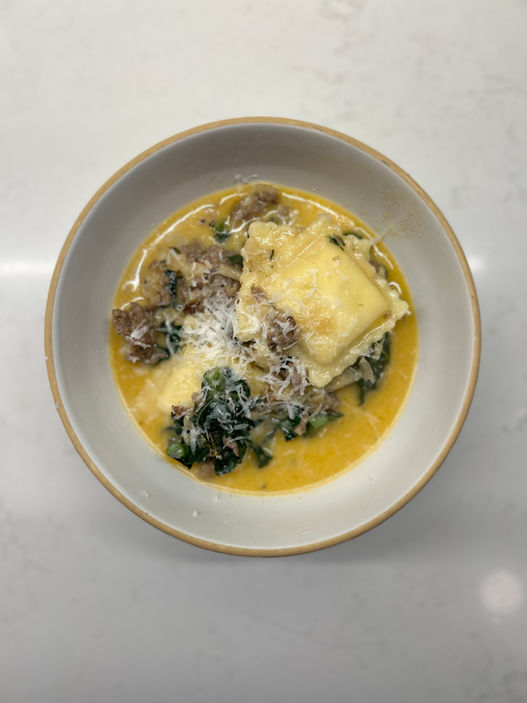 Creamy sausage and chardonnay soup with seasonal kale and tortellini. Nutritious and high protein meal prep cooked by Crewneck Chef