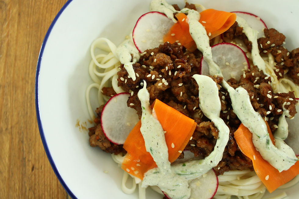 Sticky miso pork udon topped with burnt scallion aioli, served in a bowl as part of a healthy meal prep plan