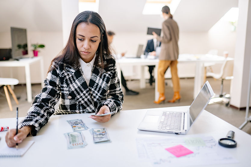 woman working at desk writing