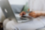 Man using laptop and looking at credit card