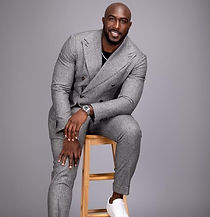 Kevin Dolce of NTN90 Business Consulting sitting on a stool in a suit