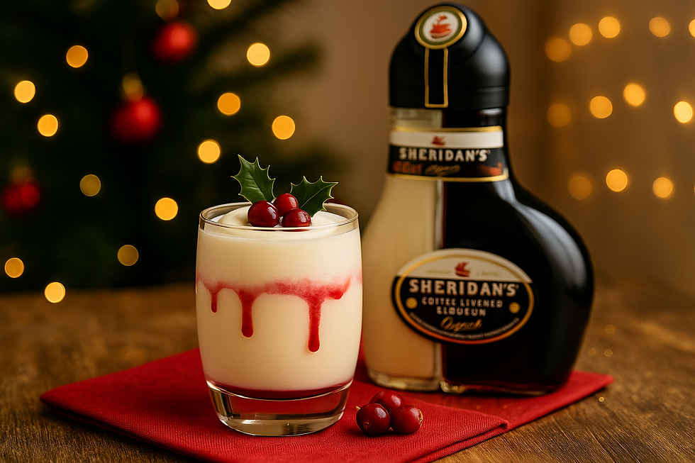 Sheridan’s Cranberry Cream Cocktail layered with cranberry juice, vodka, and Sheridan’s Coffee Layered Liqueur, topped with cream and cranberries on a festive Christmas table.