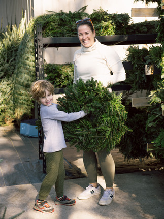 Child and woman holding a wreath at Meeting Green in Charleston