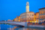 Ponte Solferino bridge and colorful houses at the Arno river waterfront in the centre of Pisa city in Tuscany, Italy