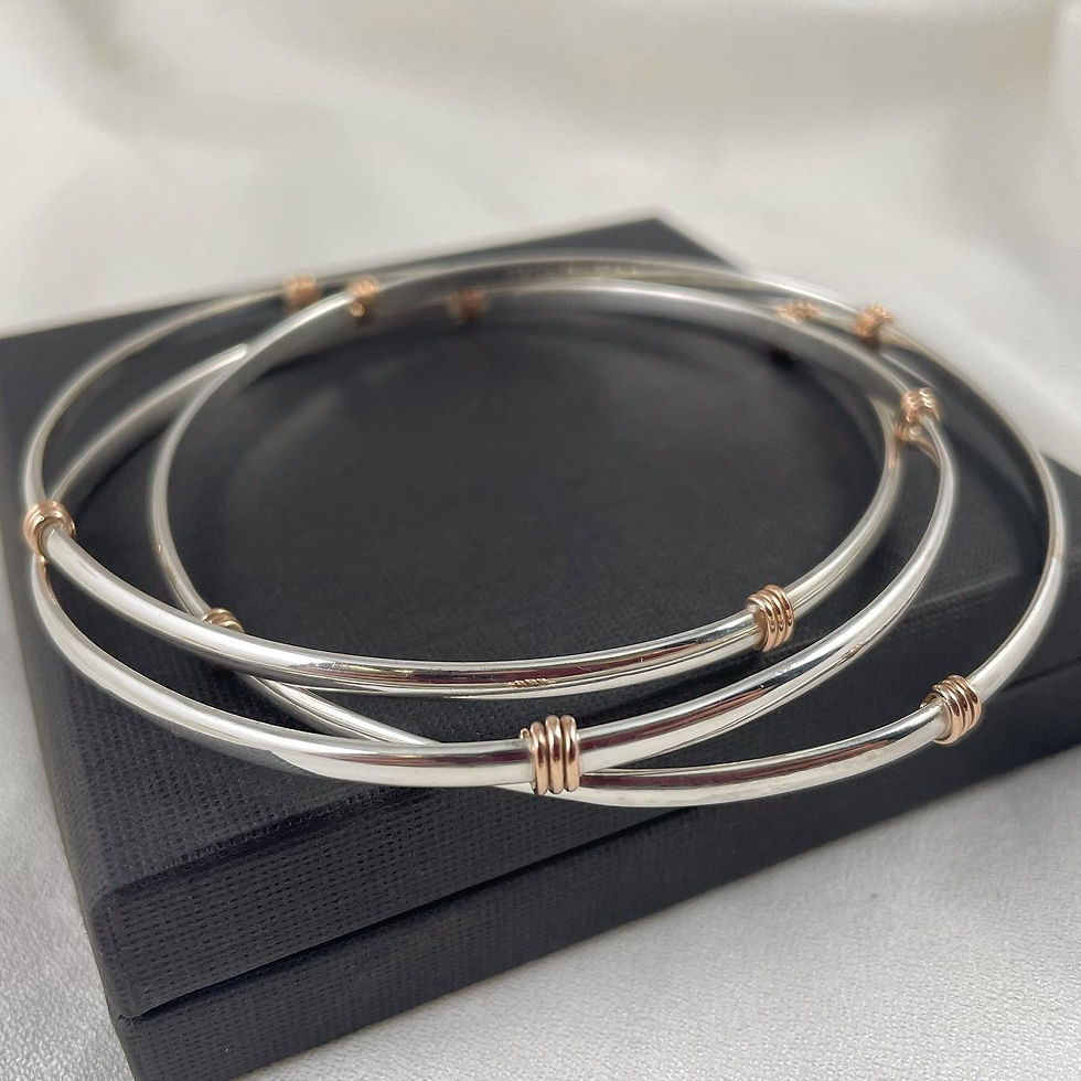 Thumbnail: Silver and 9ct Rose gold accent bangle, interlocking, gold detail. 