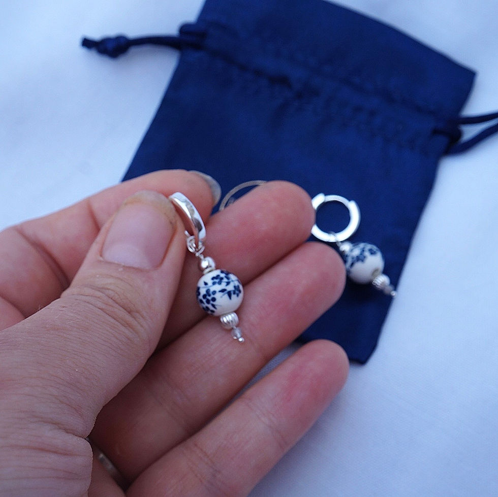 Thumbnail: Mini Huggie porcelain bead drop hoops gold and silver 