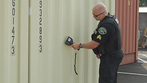 officer scanning container.jpeg