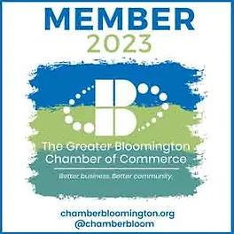 Logo for The Greater Bloomington Chamber of Commerce. It says 'Member 2023' in blue and green colors, respectively. There are horizontal paint sploshes of blue, green, and pale green colors in the back, with the logo and title of the organization on top of it.