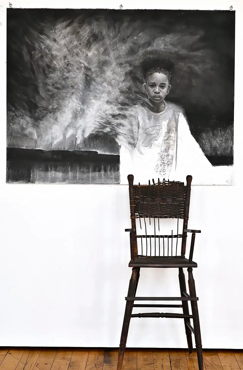 Breathless exhibition featuring a portrait and wooden chair