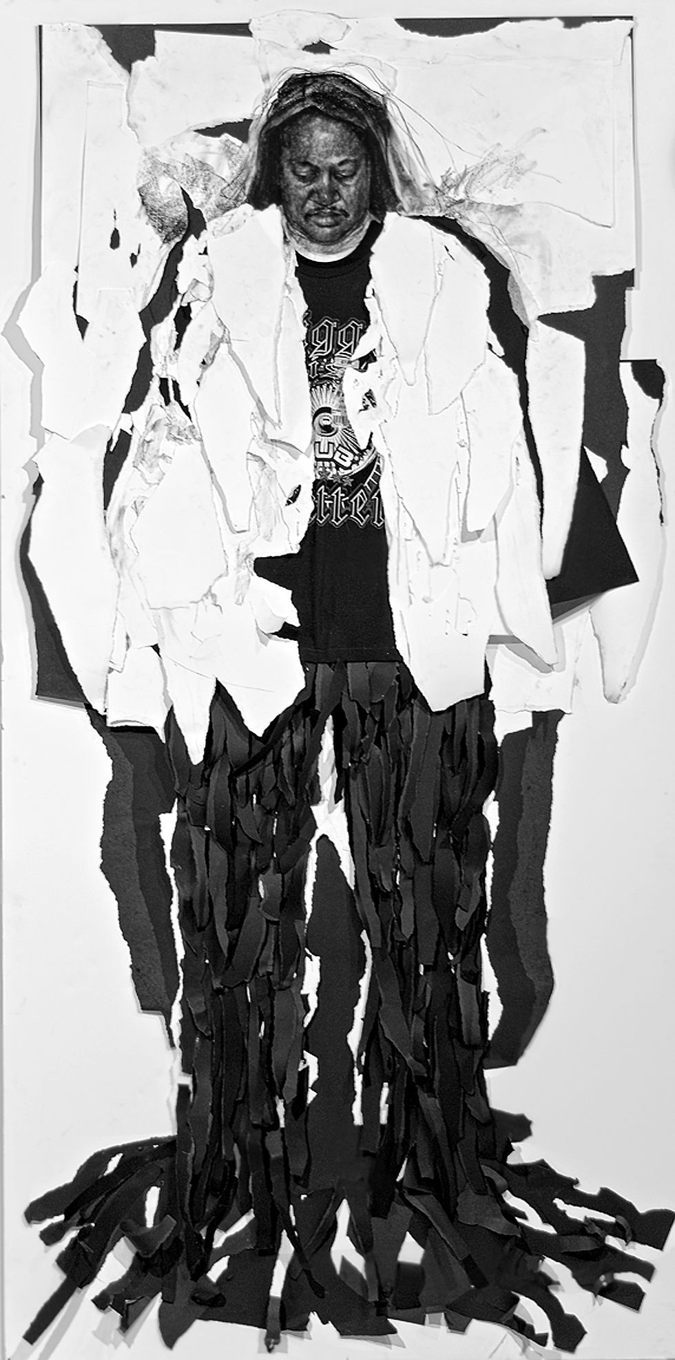 Man wearing white jacket and black pant, standing alone.