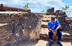 Tyrone Geter sitting on stone ruins of Kunte Kente Island The Gambia