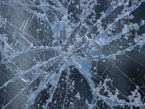 Checking car windshield for chips before freezing temperatures in Bloomington Indiana