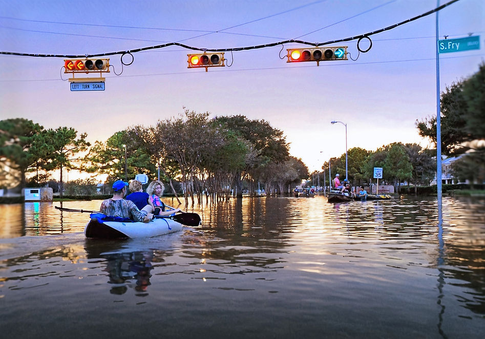 Flooded city street with people kayaking for survival