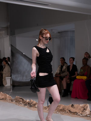 DI PETSA

'THE ARCHEOLOGY OF SELF'

Spring/Summer 2026 

​

For Spring/Summer 2026, Di Petsa delves into the deep strata of memory, myth, and the feminine psyche with The Archeology of Self. At its heart stands the Moon Goddess Selene — luminous, elusive, never whole, always glimpsed in fragments — a metaphor for memory itself. To search for her is to search for the hidden temple within ourselves, for the truths that flicker like light across water.

​

The show unfolded at Town Hall, King’s Cross — its architecture echoing the idea of excavation, of unearthing something sacred within familiar stone. Creative Director Dimitra Petsa conjured a collection where garments cling like second skin, wet drapery transformed into an eternal silhouette. Each piece seemed pulled from an ancient dream and reborn in the present: sensual yet ceremonial, fragile yet indomitable.

The staging was a total artwork. Movement directed by Leo D’Aquino carried models with lunar poise; set designer Ellie Koslowsky built an atmosphere of reverent intimacy. Music composed by Violette Wilson wove through the space like an incantation. Beauty was sculpted into its own mythology: crystalline wet-look skin by Crystabel Efemena Riley with Adored by Lottie Tomlinson, hair directed by Efidsvies for Toni & Guy, and nails by Tyler Phoenix at Mii Cosmetics.

​

Accessories extended the dream-world: sculptural footwear by Charles & Keith and Pedro, sunglasses by Maustein. Styled under the guidance of Flora Huddart and Concrete Rep, the looks fused archeology with futurism — an excavation of memory that points toward tomorrow.

With The Archeology of Self, Di Petsa reminds us that identity is not fixed but unearthed, luminous, and shifting. Like Selene, it is both memory and myth, fragment and fullness — and fashion, here, becomes a ritual of remembrance.