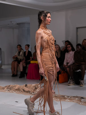 DI PETSA

'THE ARCHEOLOGY OF SELF'

Spring/Summer 2026 

​

For Spring/Summer 2026, Di Petsa delves into the deep strata of memory, myth, and the feminine psyche with The Archeology of Self. At its heart stands the Moon Goddess Selene — luminous, elusive, never whole, always glimpsed in fragments — a metaphor for memory itself. To search for her is to search for the hidden temple within ourselves, for the truths that flicker like light across water.

​

The show unfolded at Town Hall, King’s Cross — its architecture echoing the idea of excavation, of unearthing something sacred within familiar stone. Creative Director Dimitra Petsa conjured a collection where garments cling like second skin, wet drapery transformed into an eternal silhouette. Each piece seemed pulled from an ancient dream and reborn in the present: sensual yet ceremonial, fragile yet indomitable.

The staging was a total artwork. Movement directed by Leo D’Aquino carried models with lunar poise; set designer Ellie Koslowsky built an atmosphere of reverent intimacy. Music composed by Violette Wilson wove through the space like an incantation. Beauty was sculpted into its own mythology: crystalline wet-look skin by Crystabel Efemena Riley with Adored by Lottie Tomlinson, hair directed by Efidsvies for Toni & Guy, and nails by Tyler Phoenix at Mii Cosmetics.

​

Accessories extended the dream-world: sculptural footwear by Charles & Keith and Pedro, sunglasses by Maustein. Styled under the guidance of Flora Huddart and Concrete Rep, the looks fused archeology with futurism — an excavation of memory that points toward tomorrow.

With The Archeology of Self, Di Petsa reminds us that identity is not fixed but unearthed, luminous, and shifting. Like Selene, it is both memory and myth, fragment and fullness — and fashion, here, becomes a ritual of remembrance.